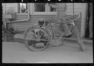 Inflating bicycle tire, Abbeville, Louisiana, 1938