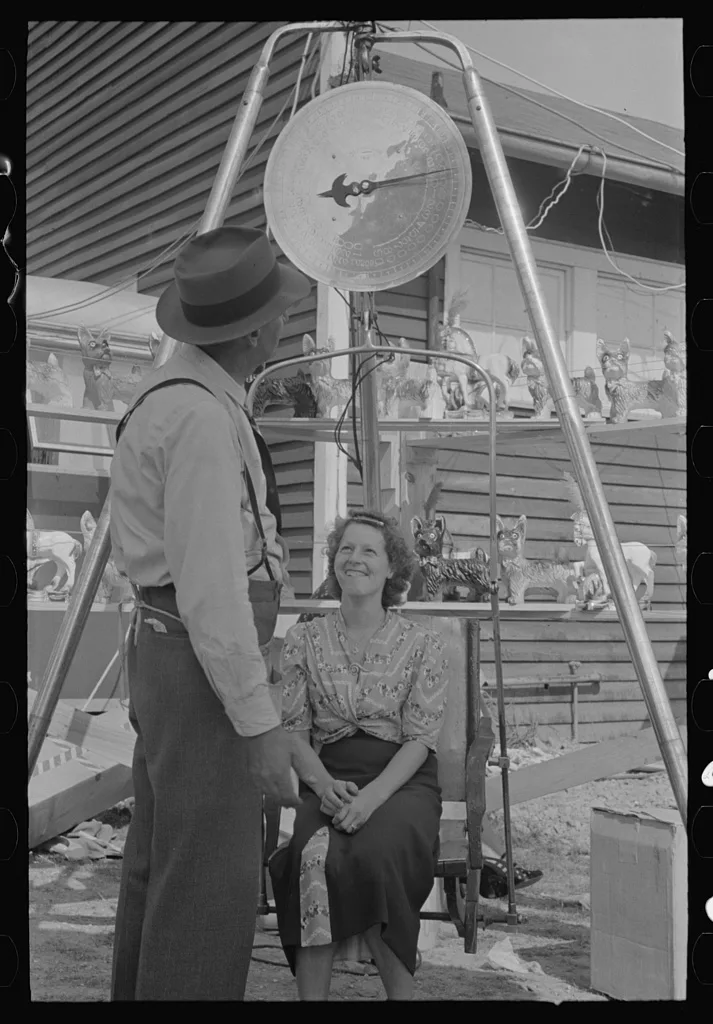 Woman being weighed, state fair, Donaldsonville, Louisiana, 1938