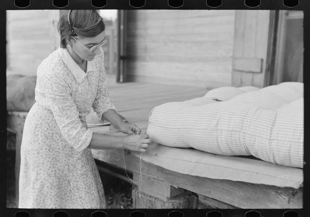 Wife of small cane farmer near Jarreau, Louisiana, making mattress of…, 1938
