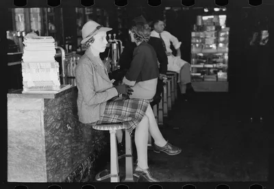 Woman sitting at soda fountain, Taylor, Texas, 1939