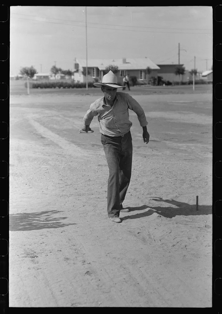 Pitching horseshoes at the Agua Fria Migratory Labor Camp, Arizona, 1940