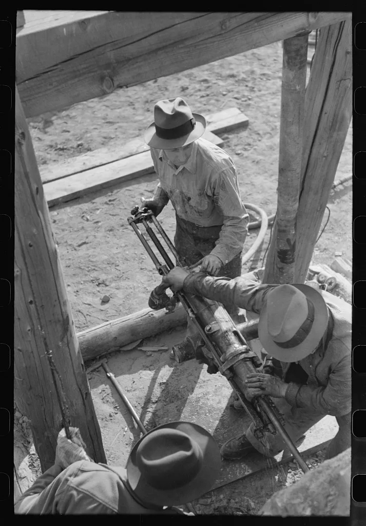 Team of two gold miners operating hand drill in contest on Labor Day,…, Colorado, 1940