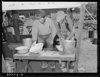 Cowboys of the SMS Ranch washing up for dinner. Ranch near Spur, Texas, 1939
