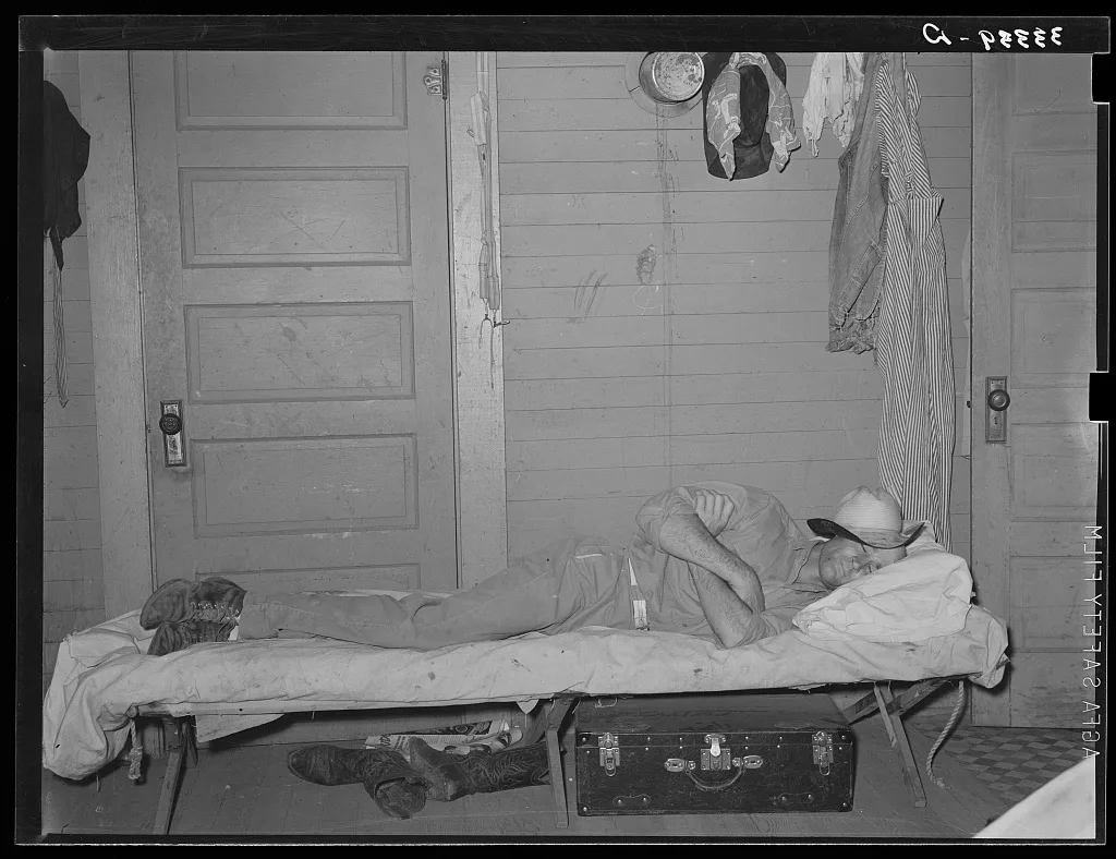 Cook of SMS Ranch asleep after dinner. Ranch near Spur, Texas, 1939