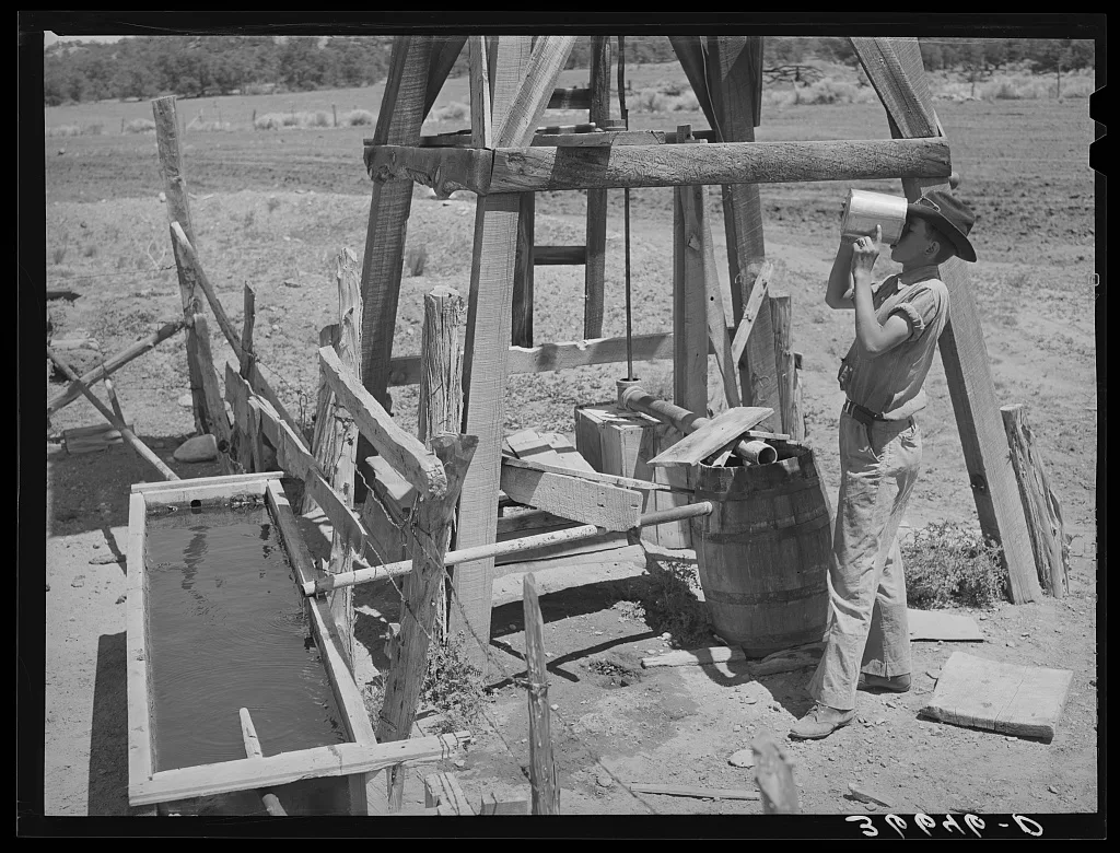 Farm boy drinking at the well. Pie Town, New Mexico, 1940