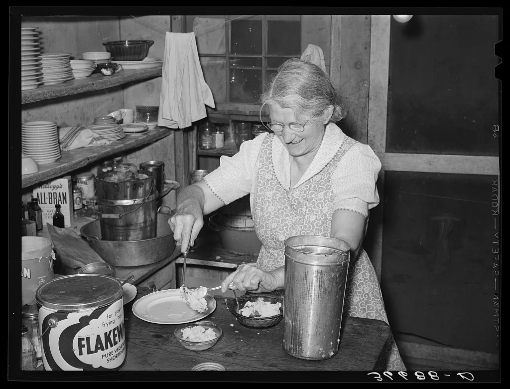 Mrs. Holley, Sr., dishing up ice cream. Pie Town, New Mexico, 1940