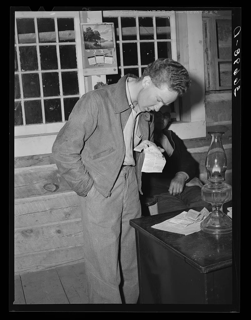 Farm boy reading jokes as his part of the program at the literary…, New Mexico, 1940