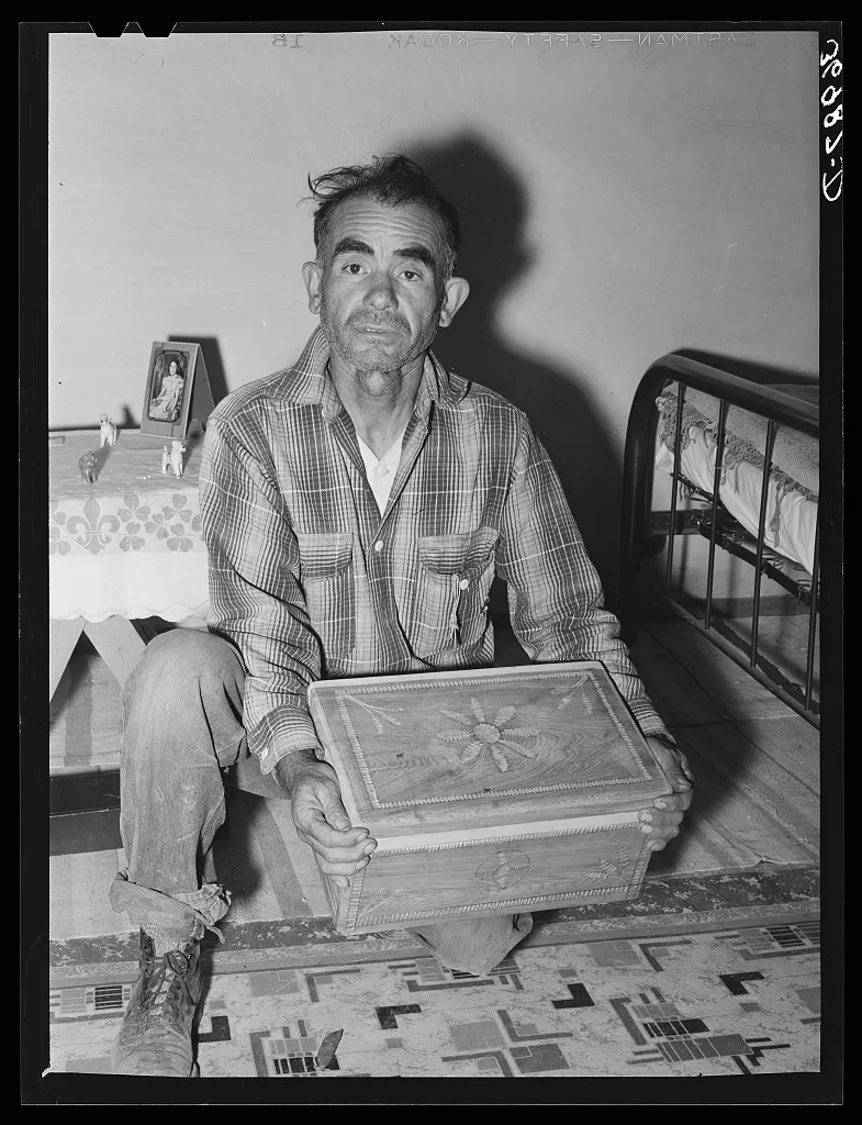 Spanish-American man with chest which he carved. He hopes to sell his…, New Mexico, 1940