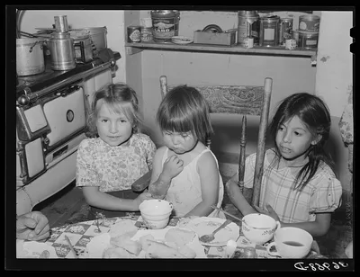 Spanish-American children at the dinner table. Chamisal, New Mexico, 1940