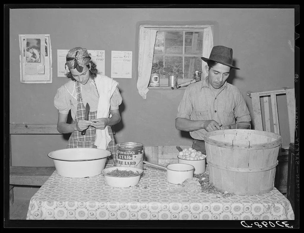 Spanish-American couple preparing fruit for canning. Chamisal, New…, New Mexico, 1940