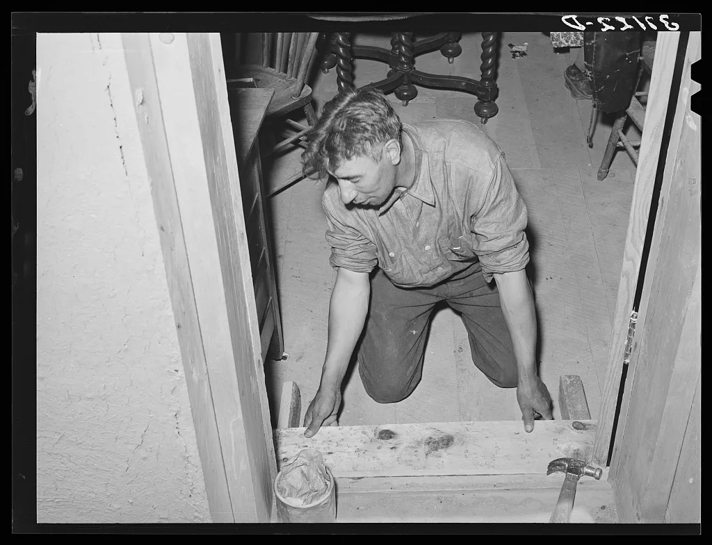 Spanish-American farmer fitting floor step into place. Amalia, New…, New Mexico, 1940