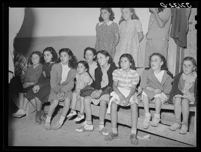 Spanish-American children watching show. Penasco, New Mexico, 1940
