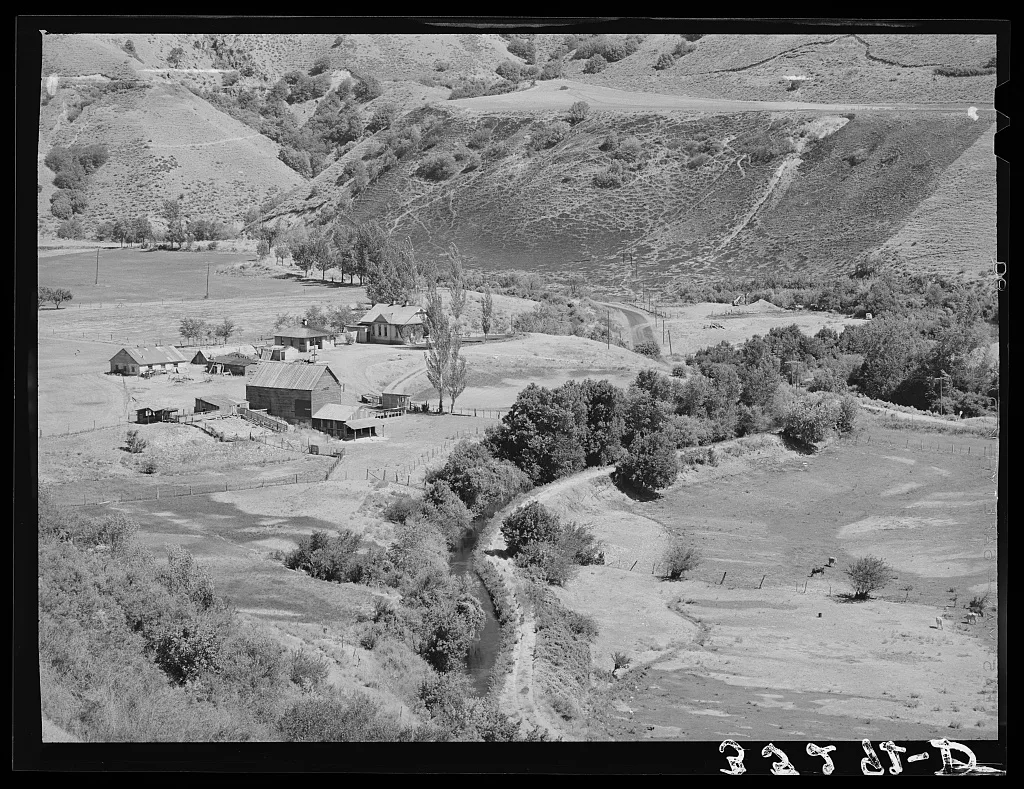 Farmstead and irrigation ditch on outskirts of Logan, Utah, 1940