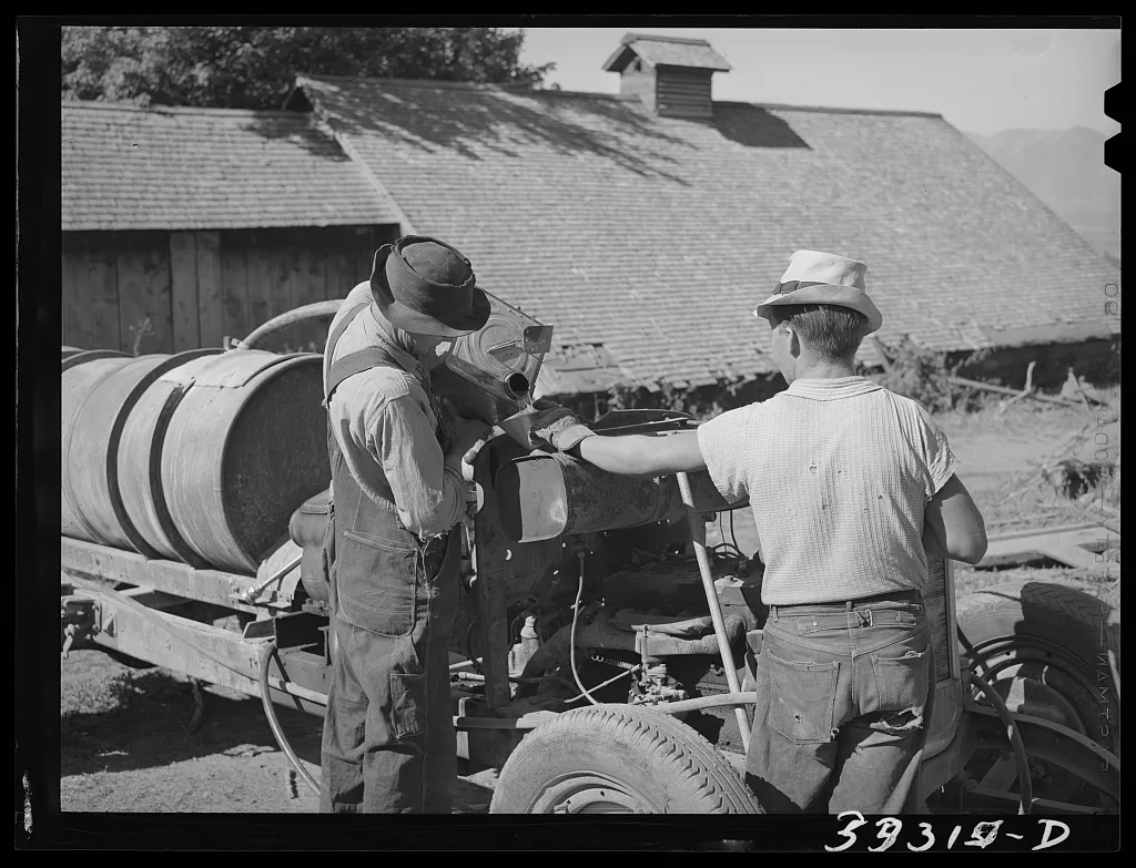 Pouring gasoline into tank of converted automobile which supplies…, Utah, 1940