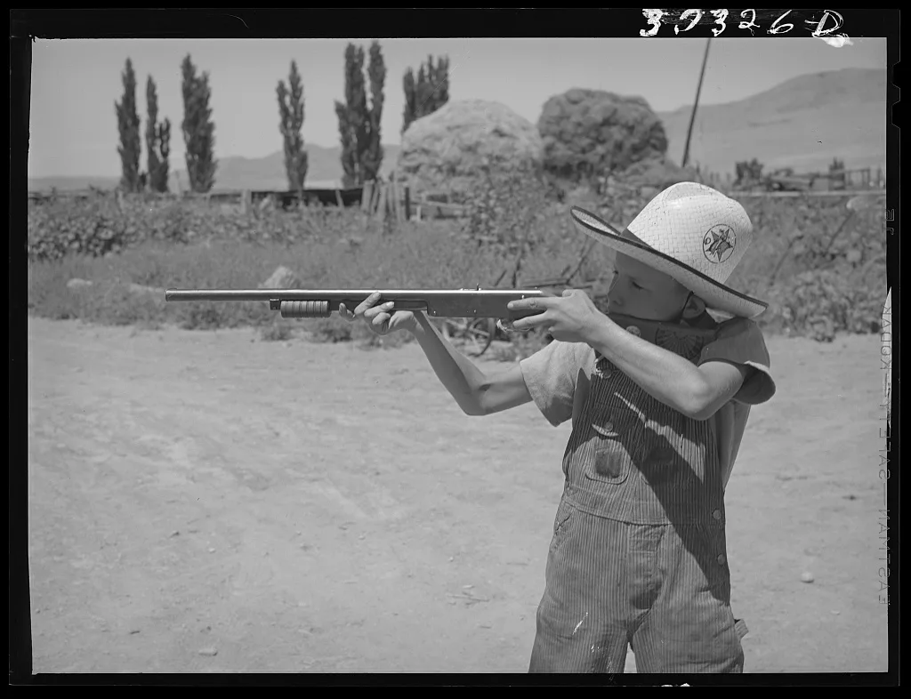 Mormon farm boy shooting air rifle. Box Elder County, Utah, 1940