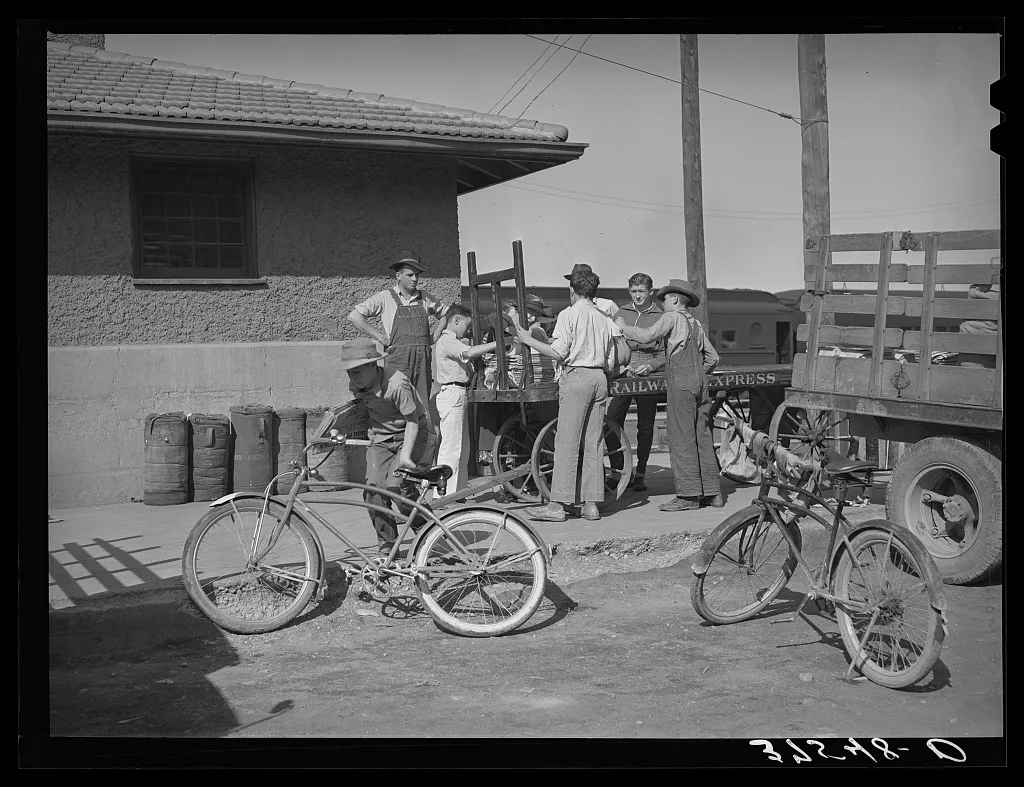 Distributing newspapers to newsboys at the railroad station.…, Colorado, 1940