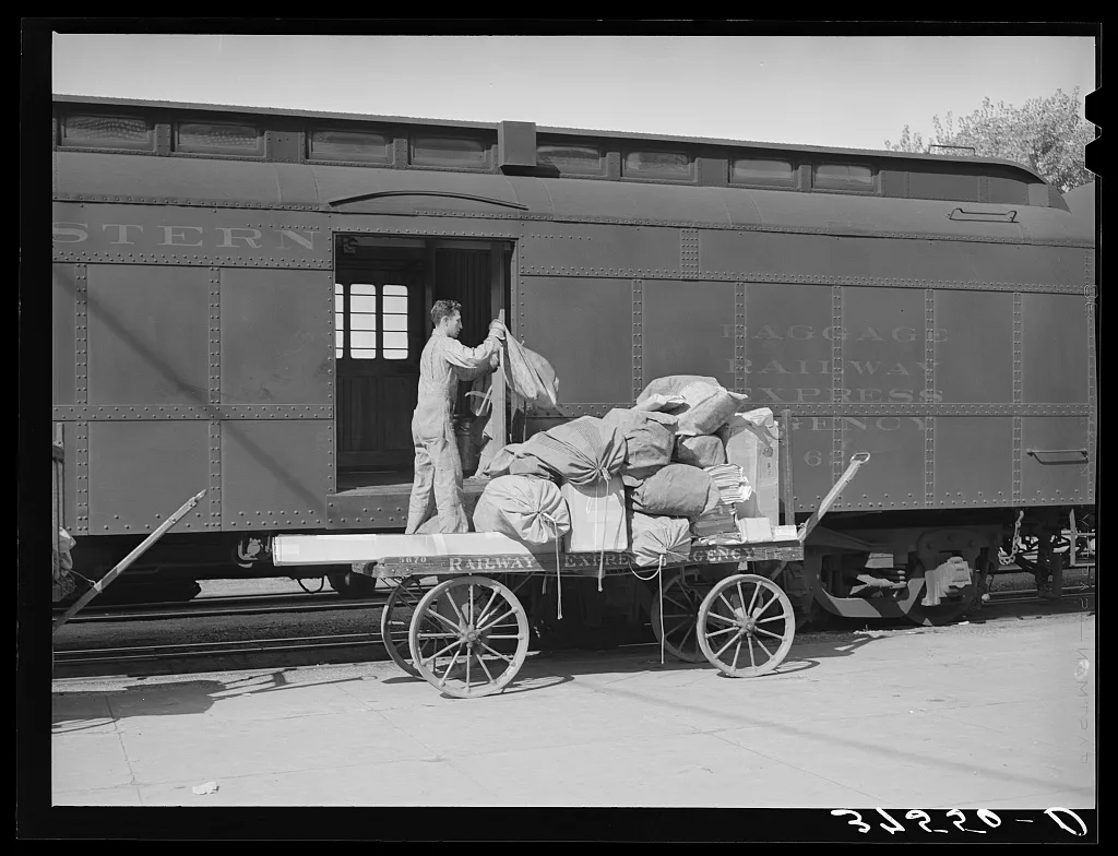 Taking off the mail at the morning train. Montrose, Colorado, 1940