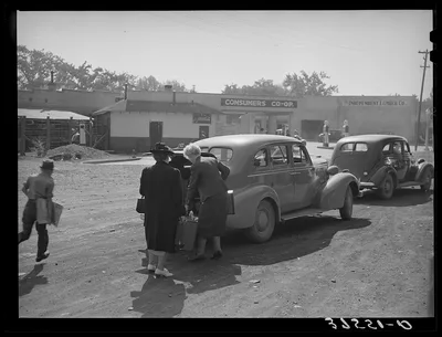 Loading baggage of train passenger into automobile. Montrose, Colorado, 1940