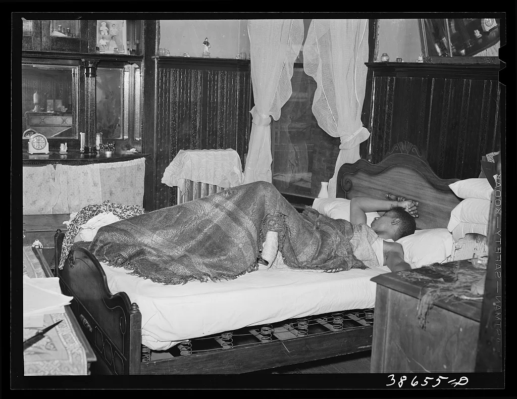 Bedroom in apartment house rented to Negroes. Chicago, Illinois, 1941