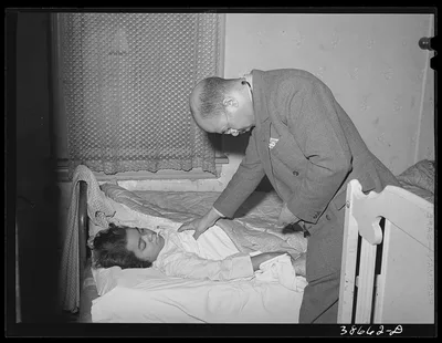[Untitled photo, possibly related to: Doctor examining patient in her…, Illinois, 1941