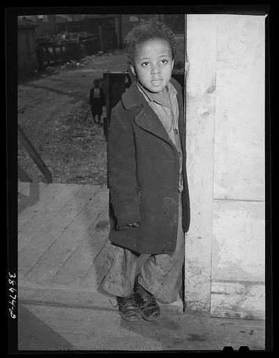 Negro girl standing in doorway. Family is on relief. Chicago, Illinois, 1941