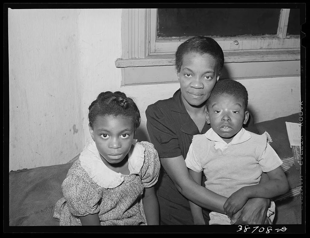 Mother with her children at home. Chicago, Illinois, 1941