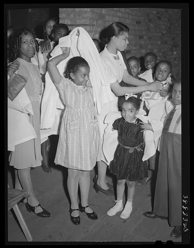 Children putting on choir robes. Pentecostal church. Chicago, Illinois, 1941
