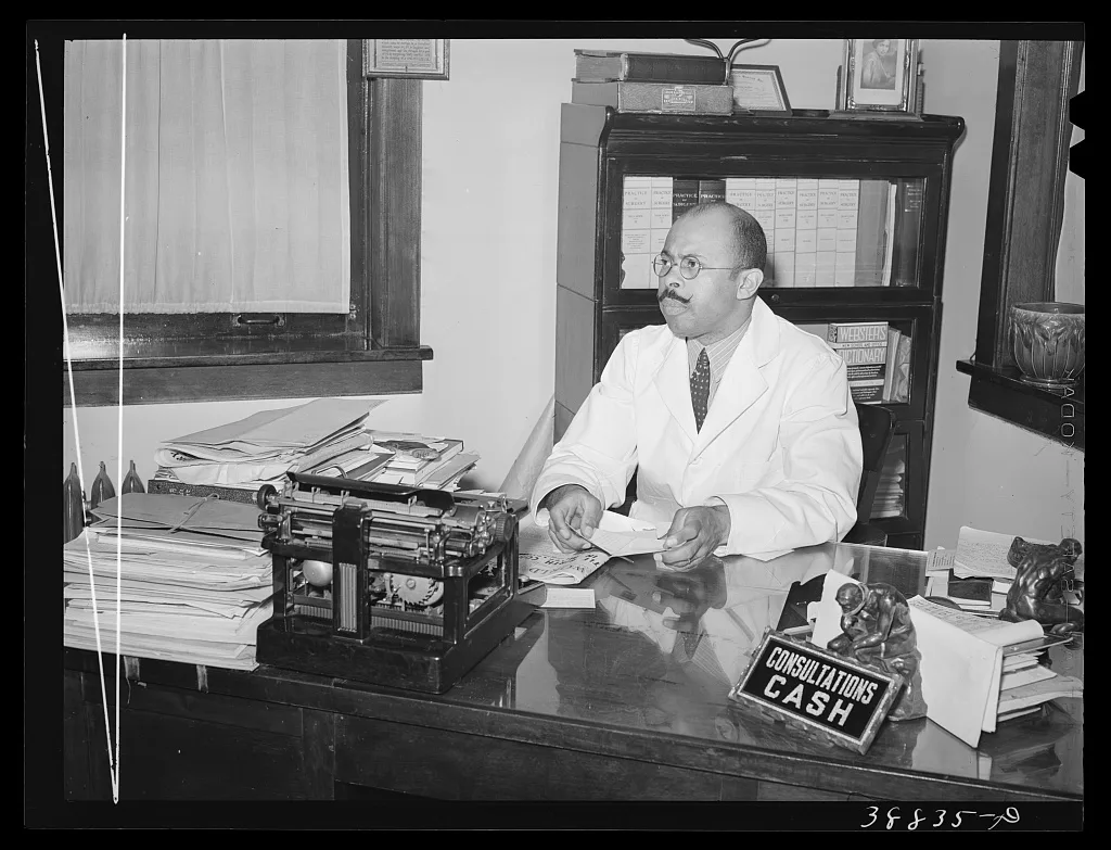 Doctor in his office. Southside of Chicago, Illinois, 1941