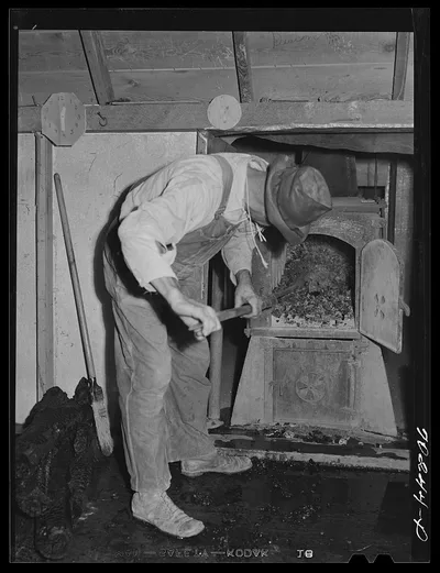 Fixing the fire at hop kiln. Yakima County, Washington, 1941
