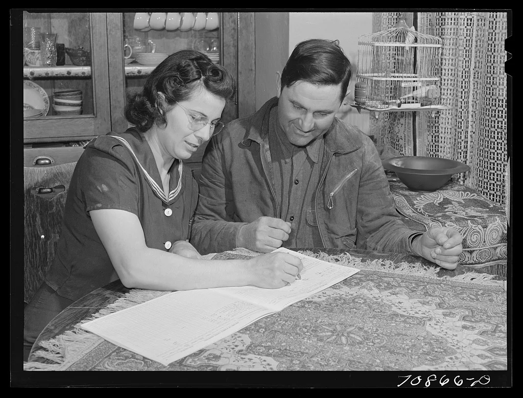 Mr. and Mrs. Lee Wagoner work on farm records. They live on the Black…, Idaho, 1941