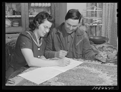 Mr. and Mrs. Lee Wagoner work on farm records. They live on the Black…, Idaho, 1941